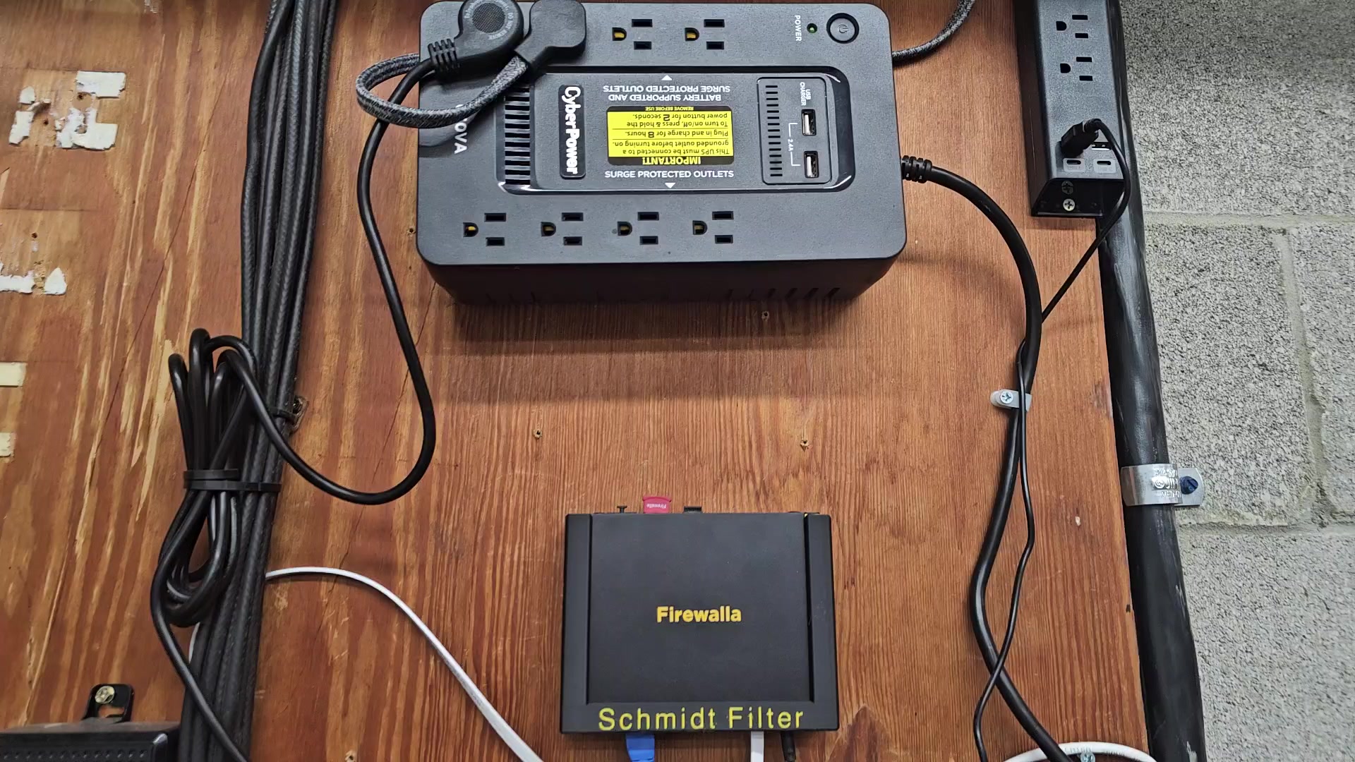Network wall mount showing Firewalla and UPS