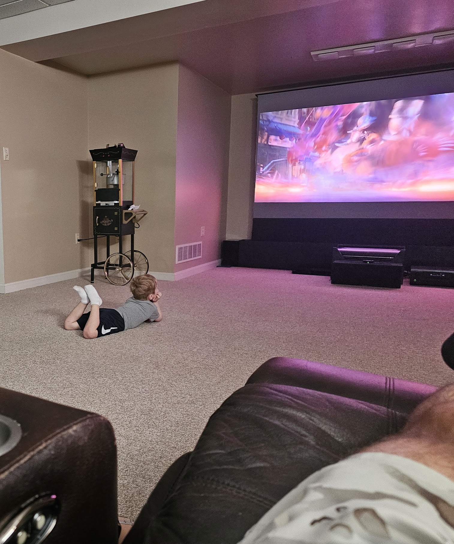 Kid watching projector on floor, September 2024