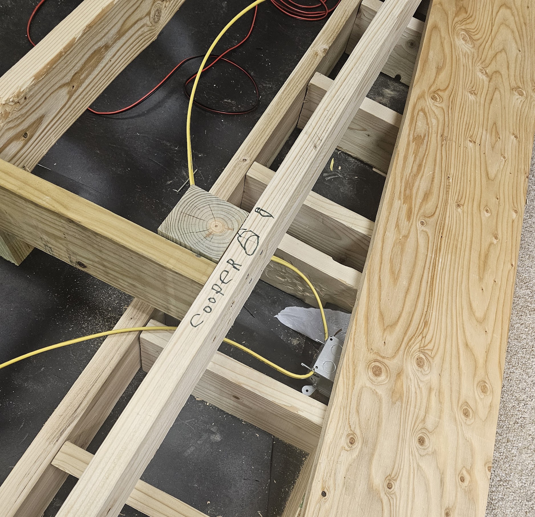 Cooper name on joist with yellow wire